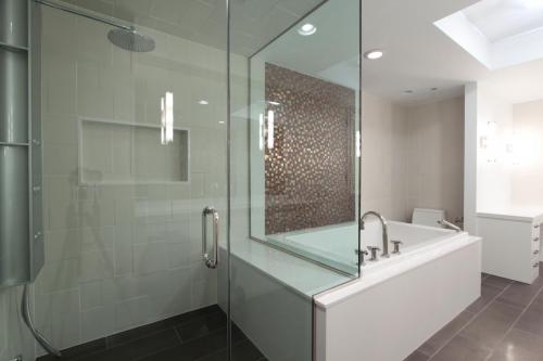 contemporary-bathroom-with-frameless-shower-and-copper-color-accent